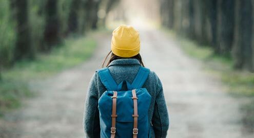 Teenage student staring down a long road representing their future
